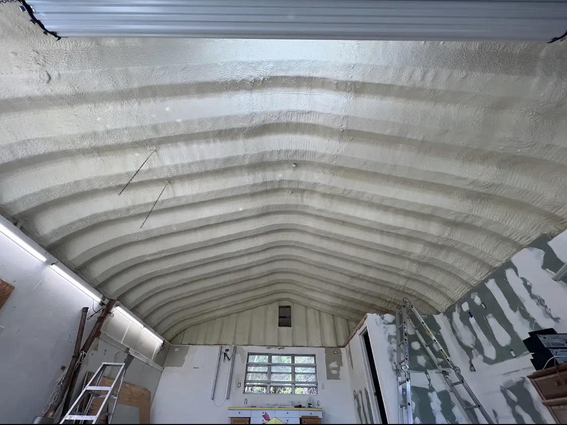 Spray polyurethane foam applied to the underside of a metal roof deck in Palm Beach